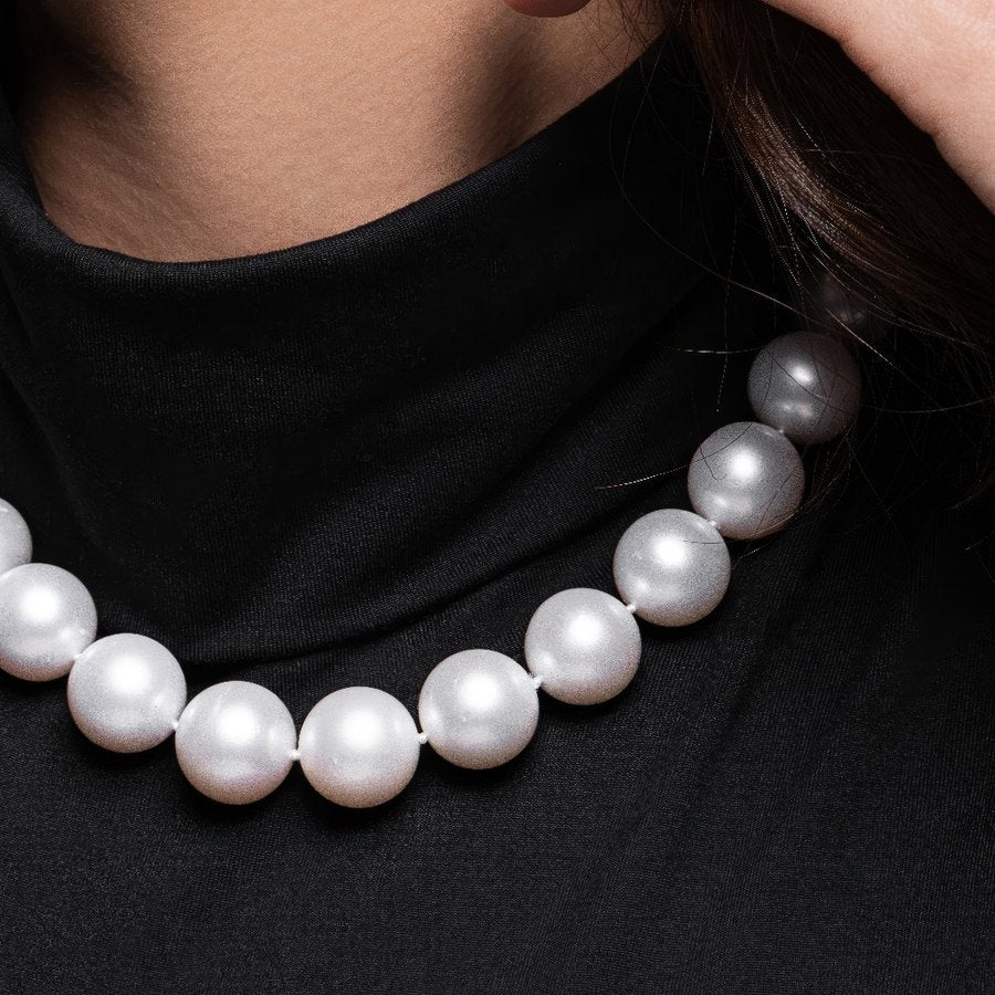 Pearl necklace worn at the collar